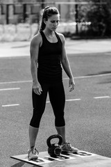 Woman with kettle bell on  competition