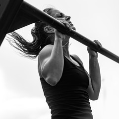 Female doing pull ups on competition