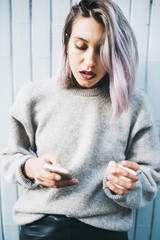 Young beautiful caucasian purple grey hair woman outdoor in the city using smart phone hand hold...
