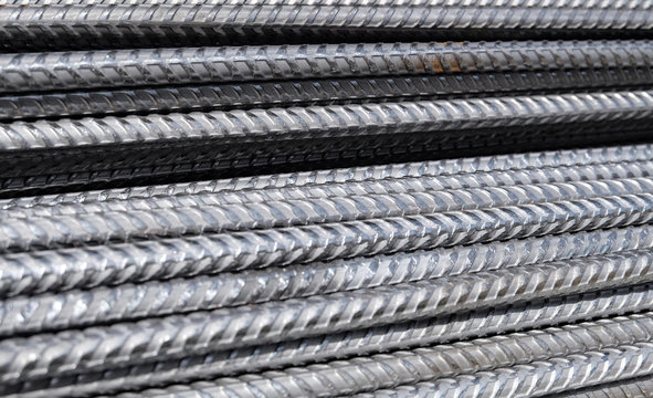 Division rebar from a construction site - a closeup of a stack of metal deformed reinforcement bars / steel rods to be used in concrete
