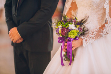 Obraz na płótnie Canvas Bride and groom at the church during a wedding ceremony