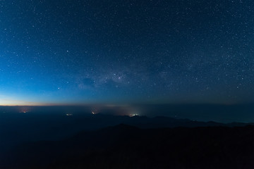 Fototapeta na wymiar Stars illuminated above the dark silhouette mountain before sunrise.