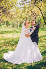 Happy bride and groom enjoying their wedding day in green nature