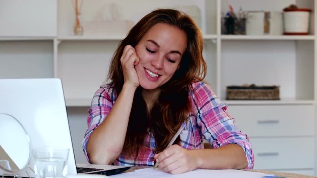 portrait of happy young woman with chestnut hair whith laptop