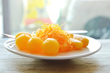 golden threads and bean paste with egg yolk fudge balls cooked in syrup variety Thai sweetmeat on plate