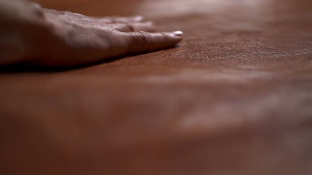 A craftsman touching a big piece of leather on the table slow motion