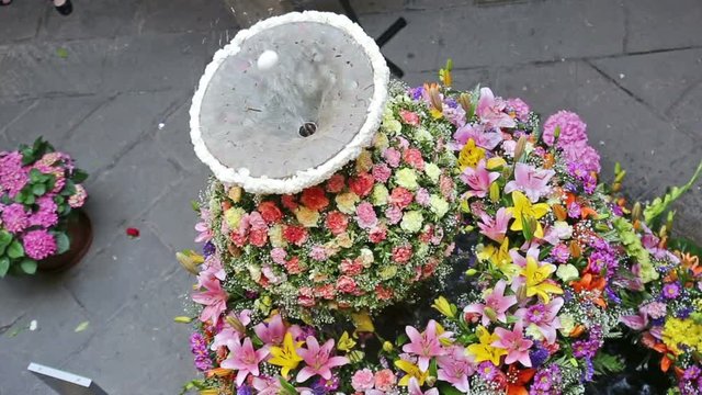 Feast of Corpus Christi. Egg on jet of water in the fountains decorated with flowers at gothic district of Barcelona
 