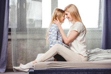 Happy mother and daughter in bed