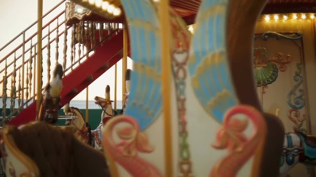 Horse rides on vintage merry-go-round carousel at fair