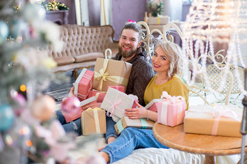 Happy couple of lovers sitting on the bed