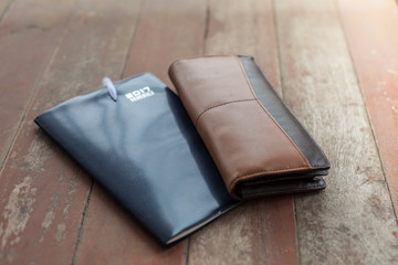 diary and men wallet on the wood floor 