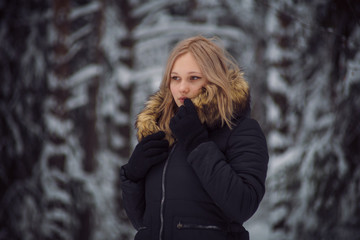girl walks on the winter forest