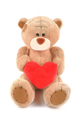 Brown teddy bear toy with heart isolated on white background