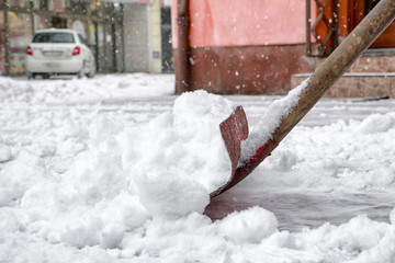 Shoveling snow in city