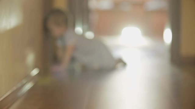 1 year old boy crawling on wooden floor towards the camera