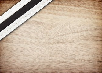 stitched leather on wooden background