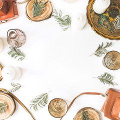 Frame of vintage retro camera, candles, branches, old tray and wooden cuts on white background. Flat lay, top view