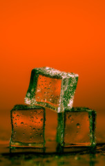 Ice cubes on colored backgrounds