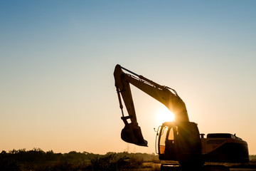 Track-type loader excavator machine on sunset background © songdech17