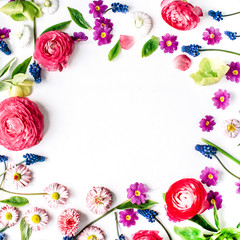 Frame of roses, muscari, chamomile, ranunculus, branches, leaves, petals and buds on white background. Flat lay, top view