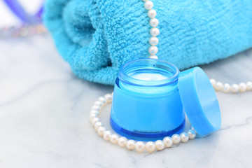Night cream in bottle and towel