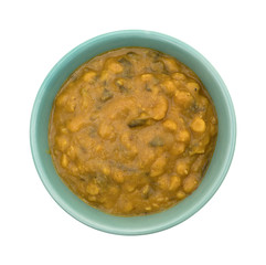 Spinach and lentils in a bowl isolated on a white background.