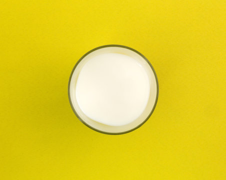 Glass of milk on a yellow tablecloth