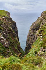 A cleft in the cliffs overlooking Moonen Bay near Dunvegan on the Isle of Skye, Scotland, UK.      