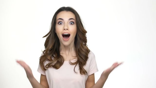 Young woman pointing finger up and having an idea isolated on a white background