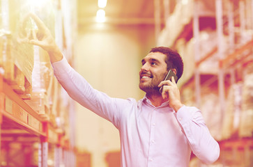 happy man calling on smartphone at warehouse