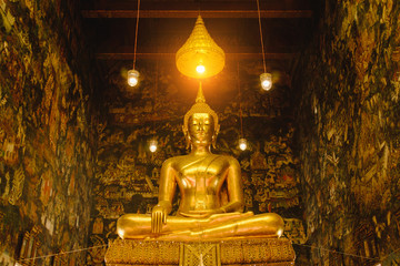 Buddha gold statue with thai art architecture in church Wat Suthat temple. This is a Buddhist temple in Bangkok .