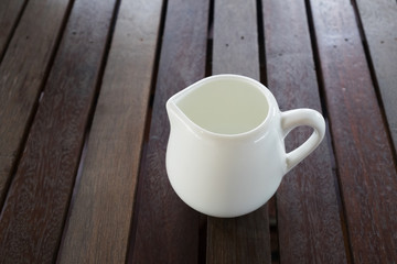 whtie jug on wooden table