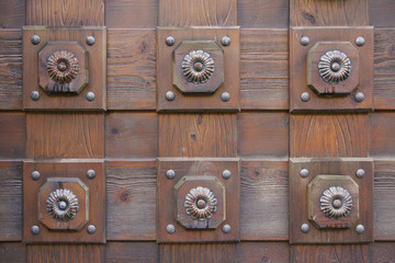 Wooden door with metal ornaments closeup. Backgrounds and textur