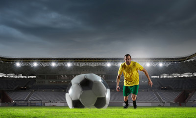 Soccer player at sport arena . Mixed media