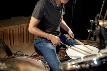 male musician playing drums and cymbals at concert