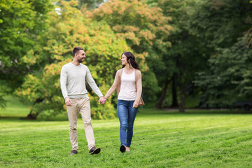 Fototapeta na wymiar happy couple walking in summer park