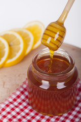 Honey in jar on a wooden background