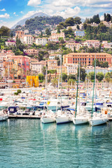 colorful houses and yachts in Menton old town harbour, France, retro toned