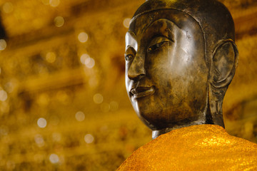 close up face on buddha head statue with Bokeh background and lighting effect.      Selective focus...