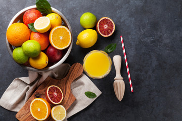 Fresh ripe citruses and juice. Lemons, limes and oranges