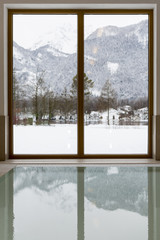 Plakat Swimming Pool with Snow Covered Mountain Lake View. Winter Idyll Window.