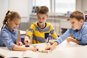 happy children building robots at robotics school