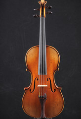 Obraz na płótnie Canvas Old wooden violin on black background