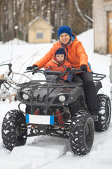 GOMEL, BELARUS - JANUARY 15, 2017: Country winter family holiday. Quad biking in the winter.
