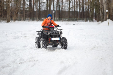 GOMEL, BELARUS - JANUARY 15, 2017: Country winter family holiday. Quad biking in the winter.