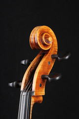 Detail of old wooden violin on black background