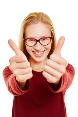 Blond woman holding her thumbs up