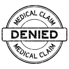 Grunge black medical claim denied round rubber stamp on white ba