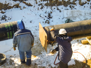 The workers engaged in the construction of the pipeline. Welders build the pipeline. Installation work in the construction and installation of the pipeline