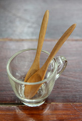 Wooden spoon in a clear glass coffee cup on the table.